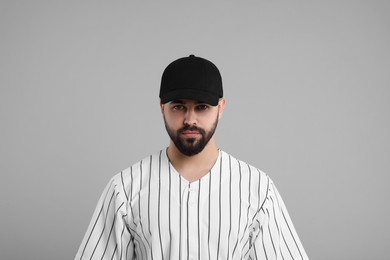 Photo of Man in stylish black baseball cap on light grey background