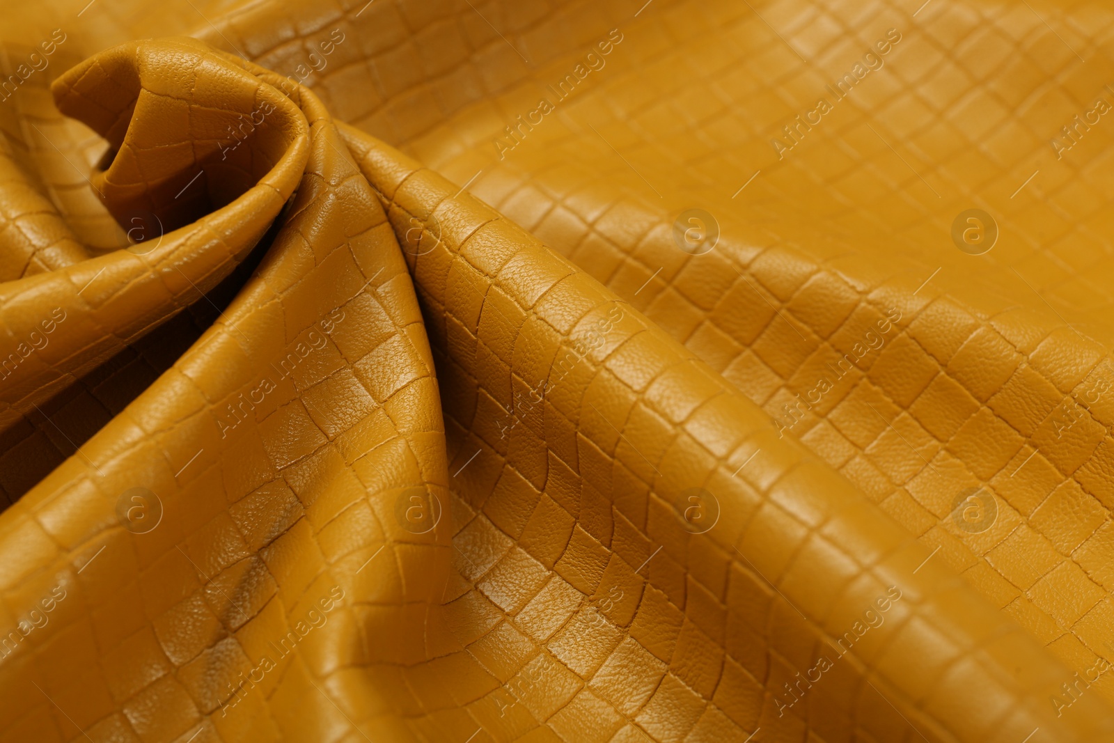 Photo of Beautiful yellow leather as background, closeup view