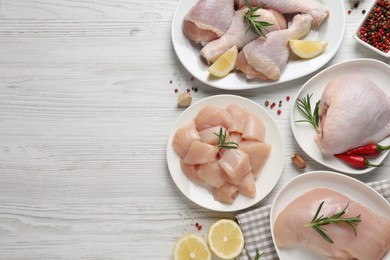 Photo of Flat lay composition with fresh raw chicken meat on white wooden table. Space for text