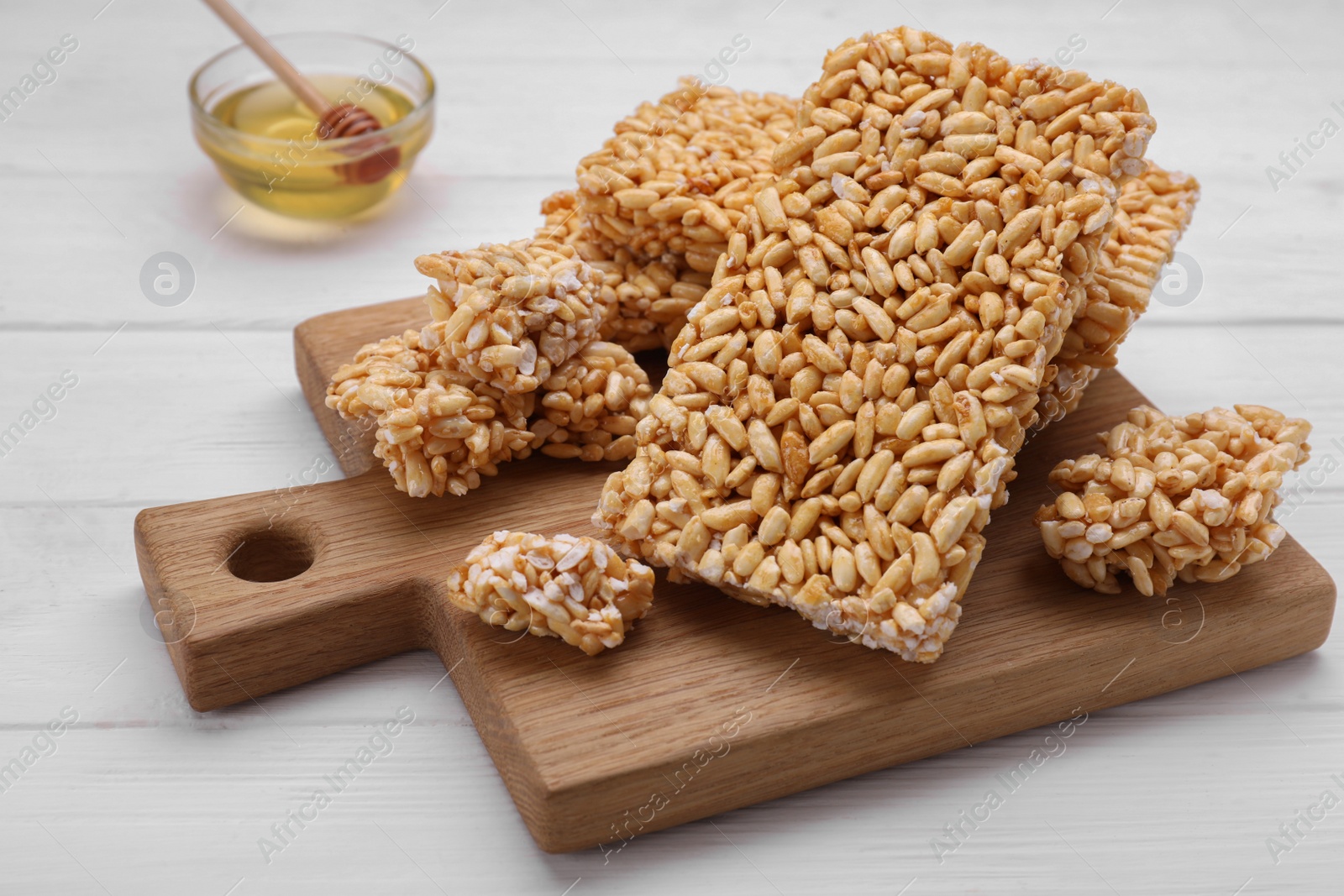 Photo of Puffed rice bars (kozinaki) on white wooden table