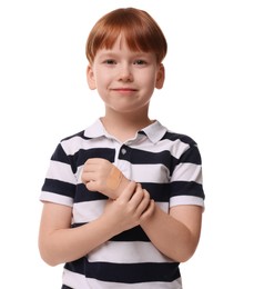 Little boy with sticking plaster on hand against light blue background