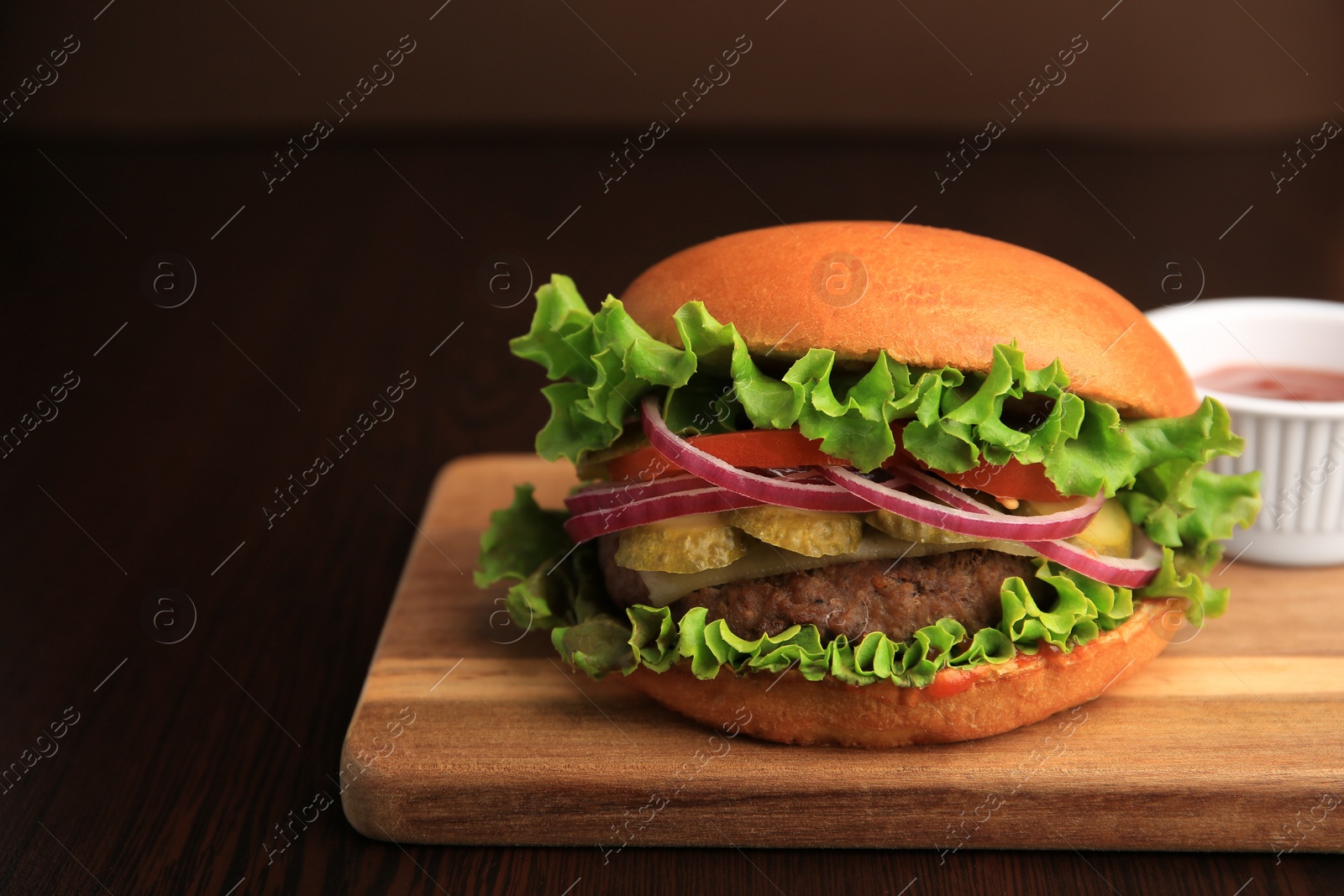 Photo of One tasty burger on wooden table. Space for text