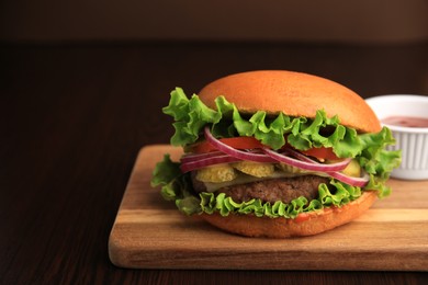 Photo of One tasty burger on wooden table. Space for text