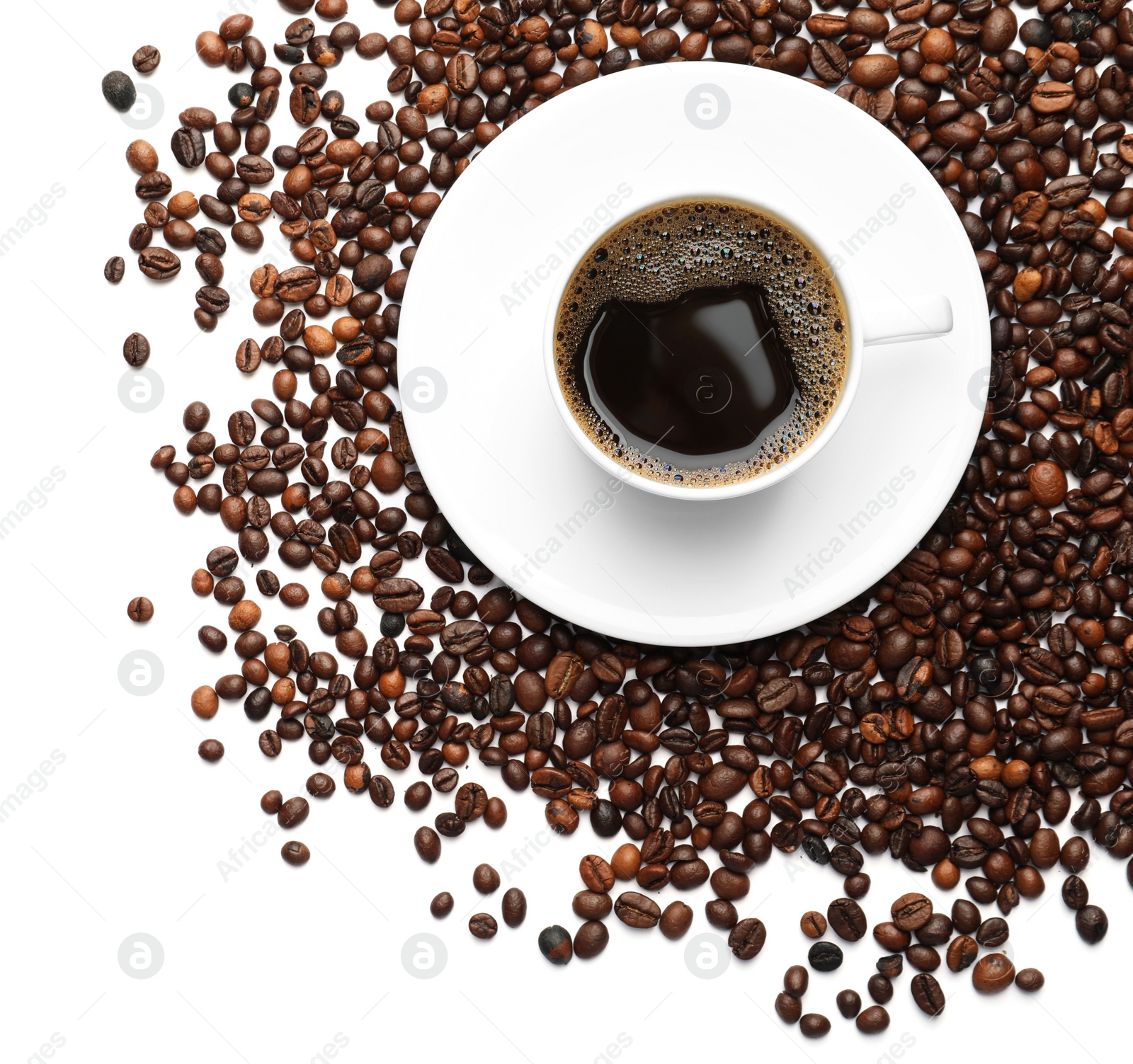 Photo of Roasted coffee beans and cup of hot beverage on white background, top view