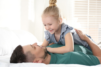 Photo of Dad and daughter spending time together at home. Happy Father's Day