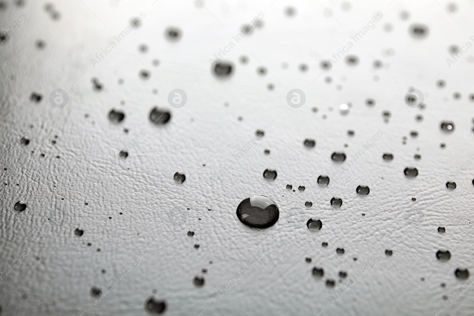 Photo of Many clean water drops on black background