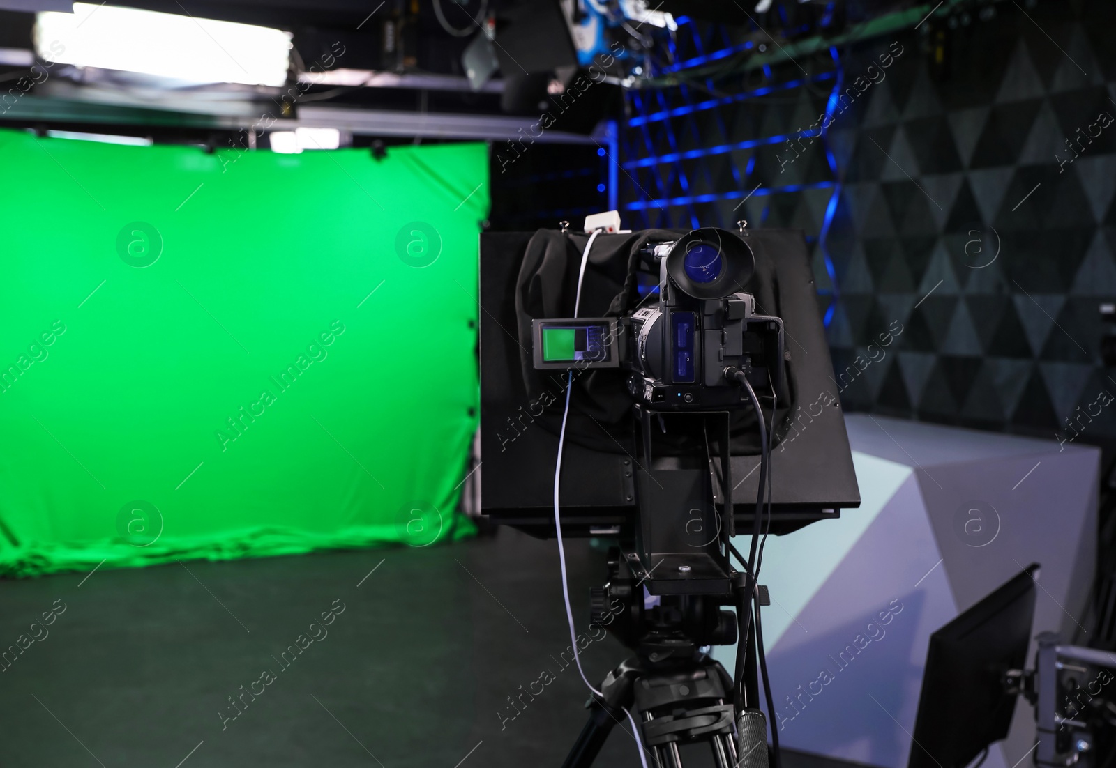 Photo of Modern video recording studio with professional equipment, focus on camera