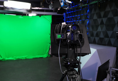 Photo of Modern video recording studio with professional equipment, focus on camera