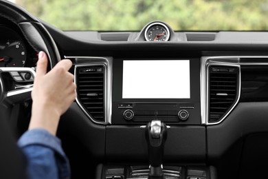 Woman using navigation system while driving her car, closeup