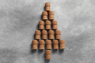 Photo of Christmas tree made of wine corks on grey table, top view