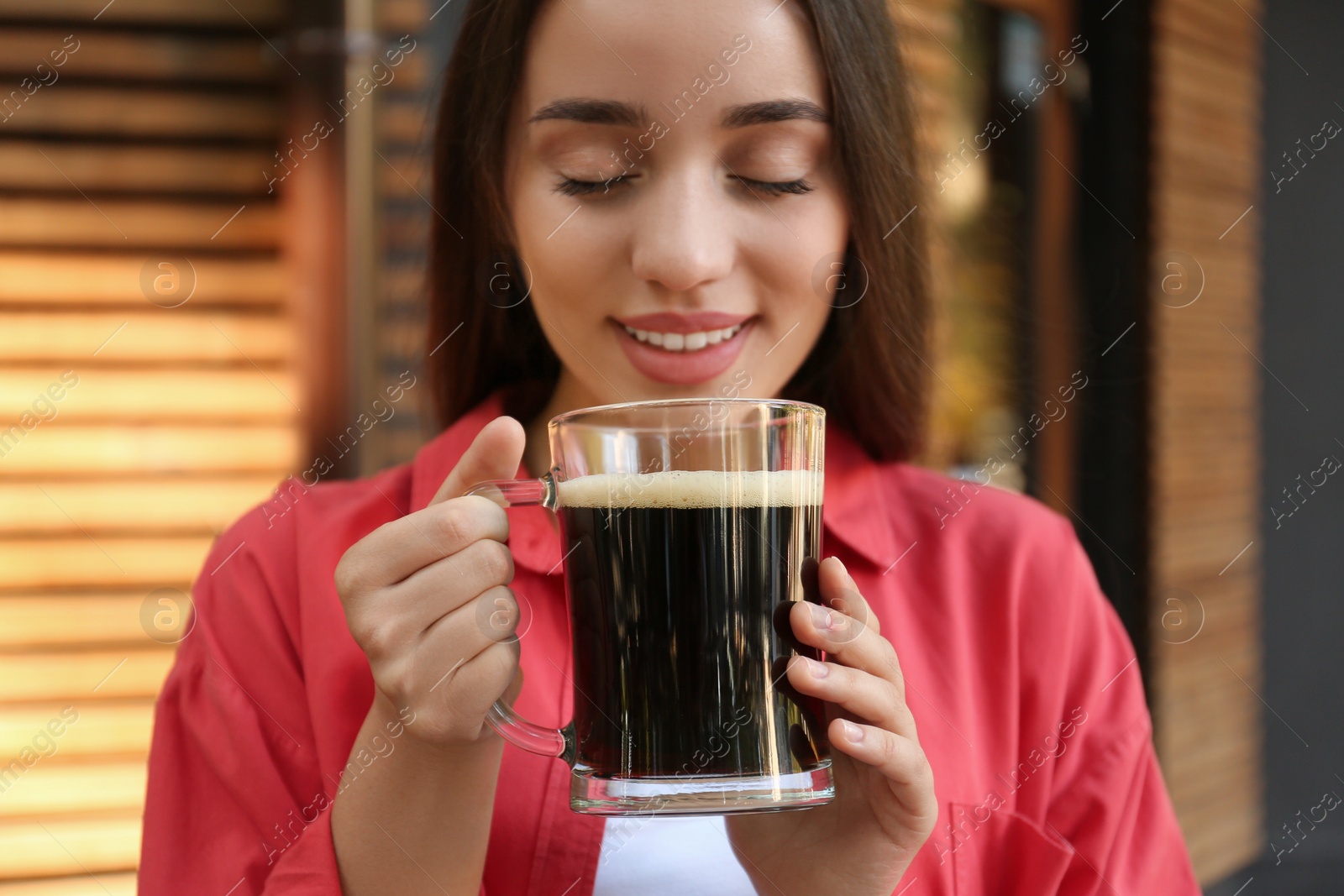 Photo of Beautiful woman with cold kvass outdoors. Traditional Russian summer drink