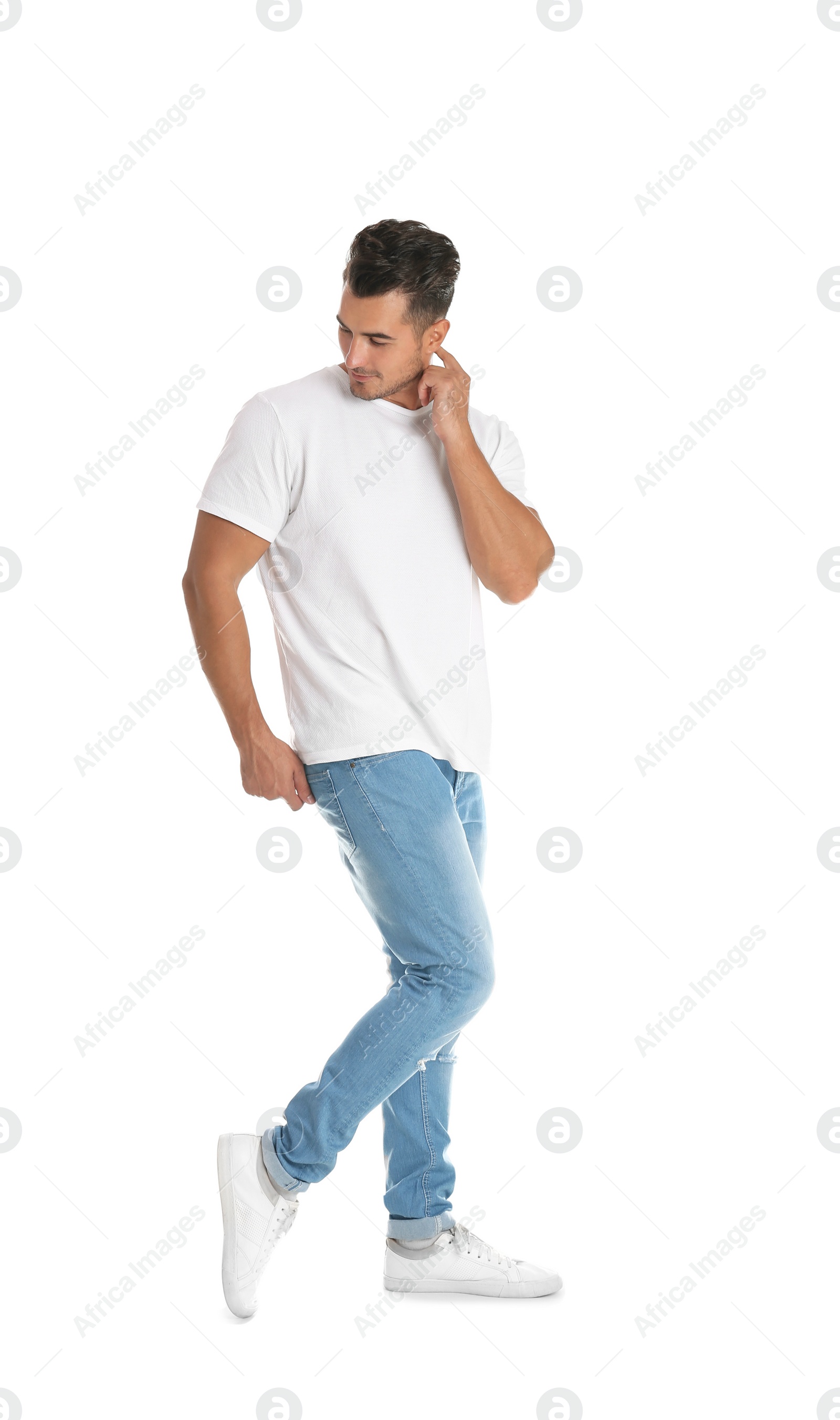 Photo of Young man in stylish jeans on white background