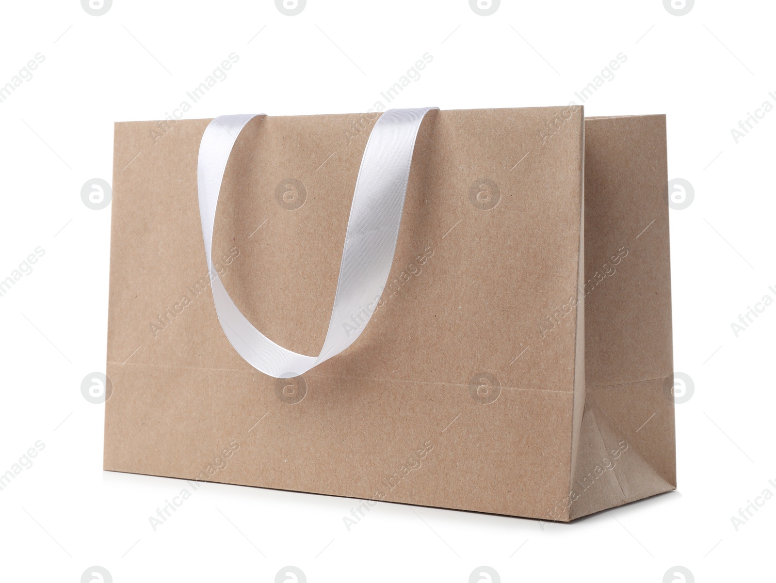 Photo of Paper shopping bag with ribbon handles on white background. Mockup for design