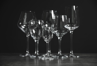 Set of bar glassware on table against dark background