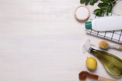 Photo of Flat lay composition with different cleaning supplies on light wooden background, space for text