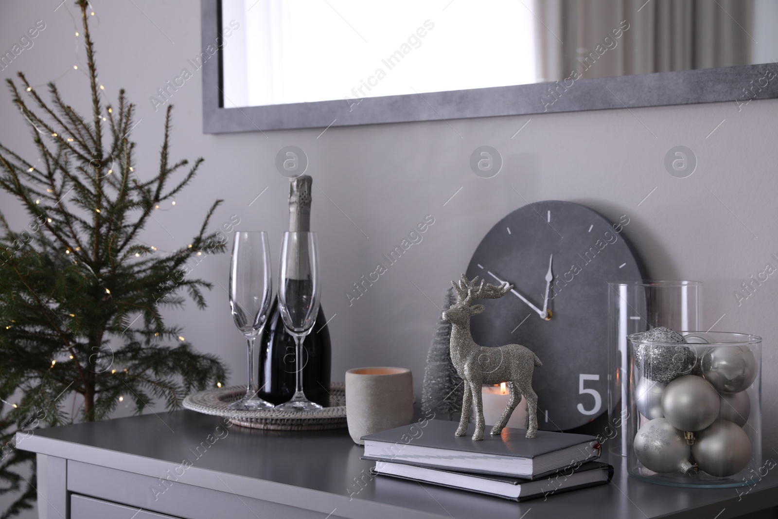 Photo of Christmas tree and decor on table indoors. Interior design