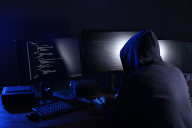 Hacker with computers in dark room. Cyber crime