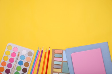 Photo of Flat lay composition with different school stationery on yellow background, space for text. Back to school