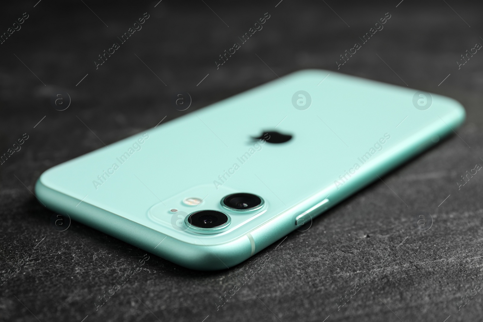 Photo of MYKOLAIV, UKRAINE - JULY 9, 2020: New modern Iphone 11 Green on black background, closeup