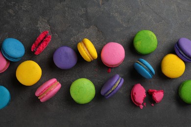 Photo of Different delicious macarons on grey table, flat lay