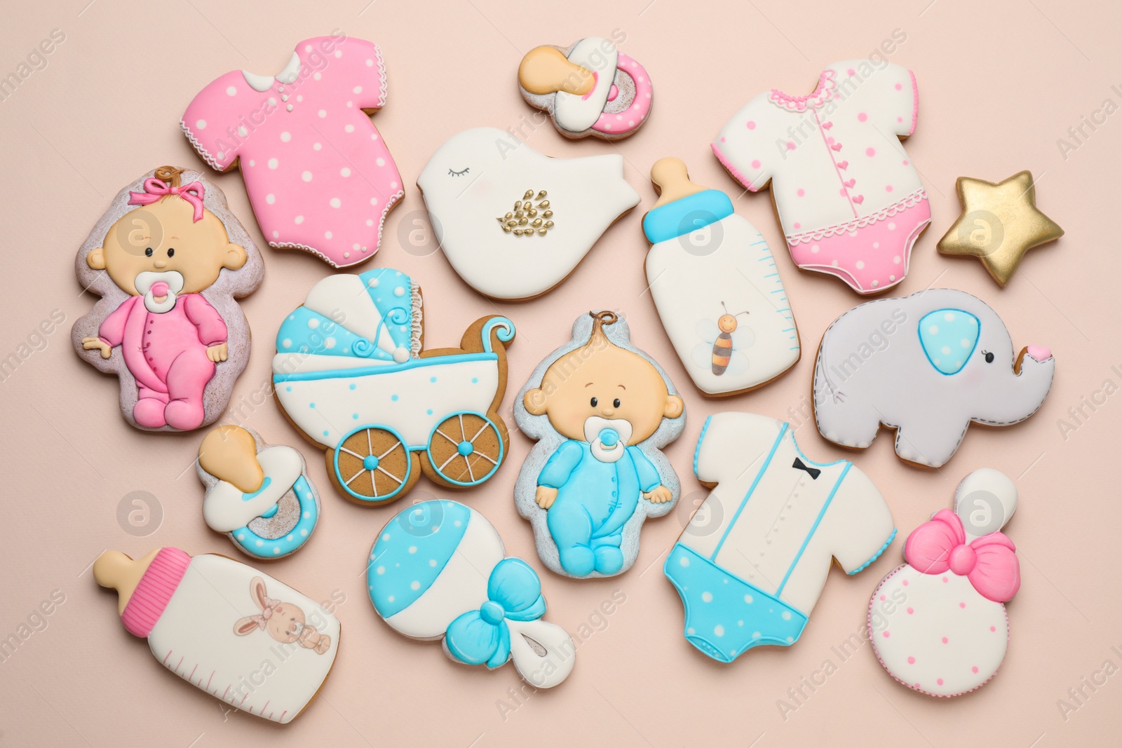 Photo of Set of baby shower cookies on light pink background, flat lay