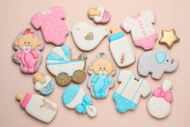 Set of baby shower cookies on light pink background, flat lay