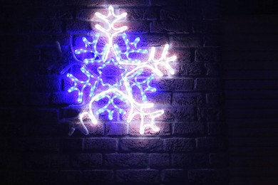 Decorative snowflake on brick wall. Christmas decor