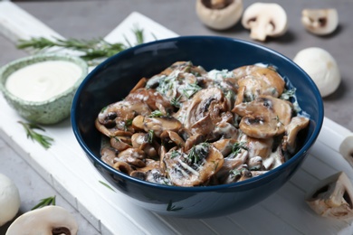 Bowl of fried mushrooms with sauce on table