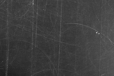 Texture of scratched black surface as background, closeup