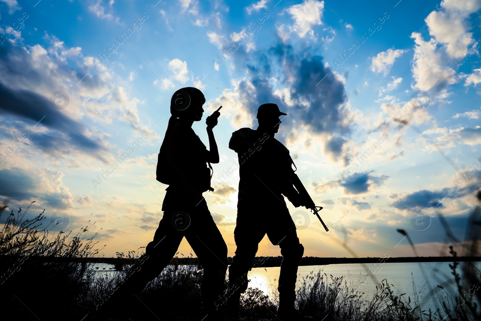 Photo of Soldiers in uniform patrolling outdoors. Military service