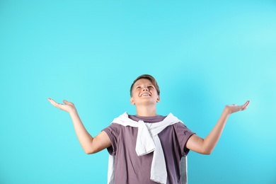 Photo of Teenage boy in casual clothes on color background