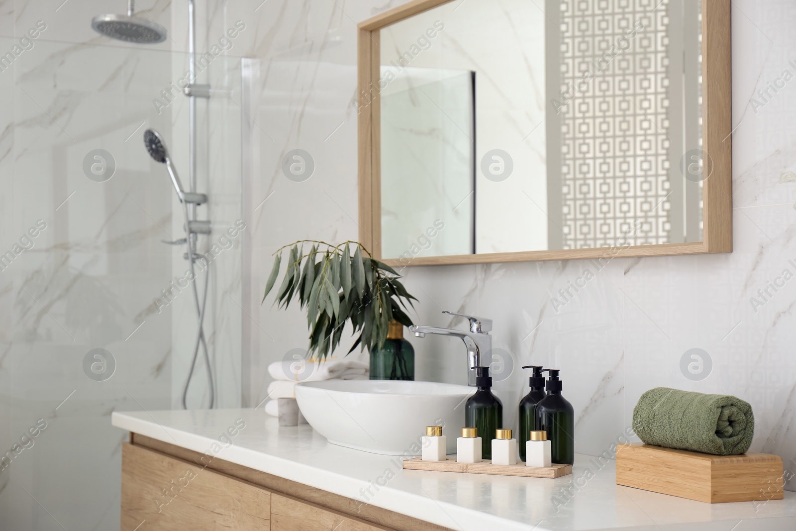 Photo of Bathroom counter with stylish vessel sink and toiletries. Interior design