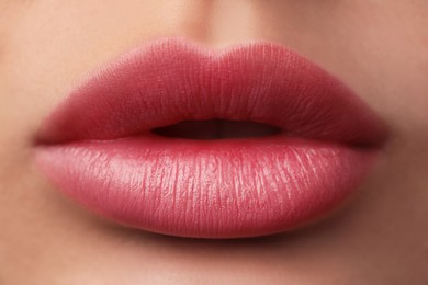 Image of Woman with beautiful perfect lips after permanent makeup procedure, closeup