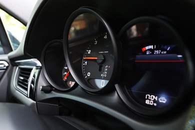 Photo of Speedometer and tachometer inside of modern car, closeup