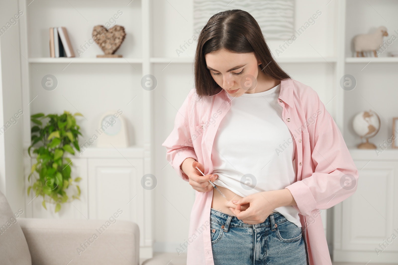 Photo of Diabetes. Woman making insulin injection into her belly at home, space for text