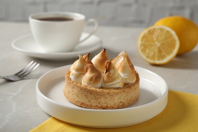 Delicious lemon meringue pie served on white table