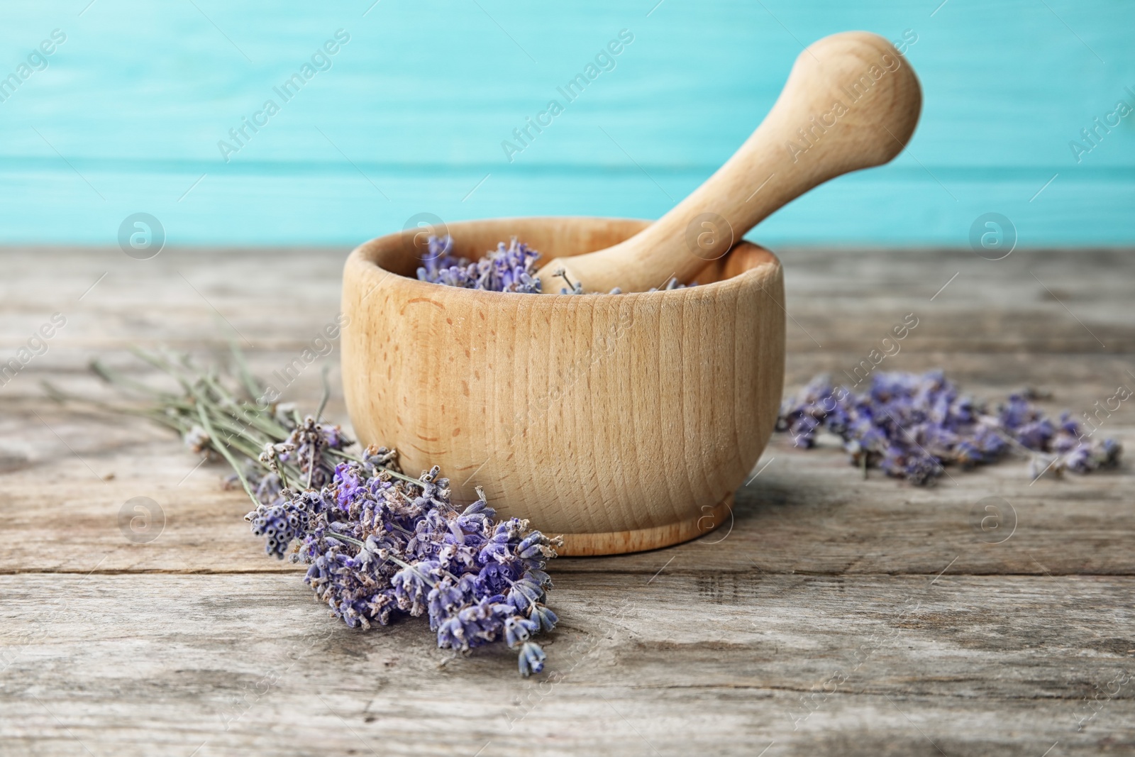 Photo of Mortar with lavender flowers on table. Ingredient for natural cosmetic