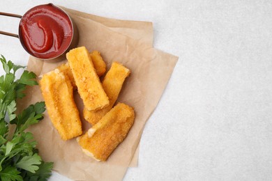 Photo of Tasty fried mozzarella sticks served with parsley and ketchup on white table, flat lay. Space for text
