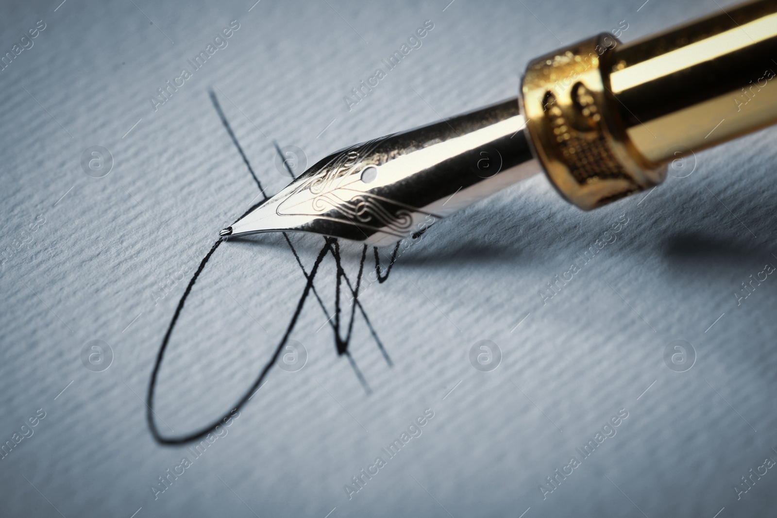 Image of Signing on sheet of paper with fountain pen, closeup