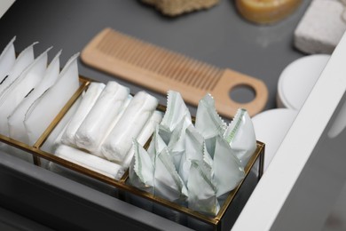 Storage of different feminine hygiene products in drawer, closeup
