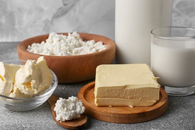 Piece of tasty homemade butter and dairy products on grey table