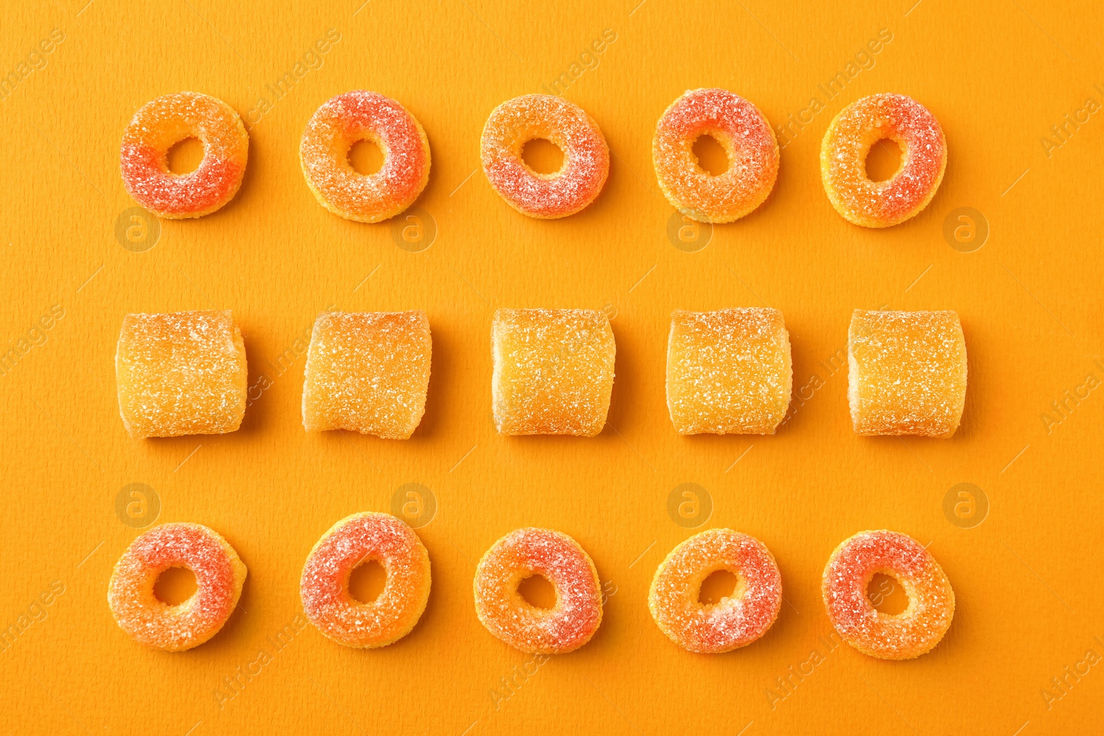 Photo of Flat lay composition with delicious jelly candies on color background