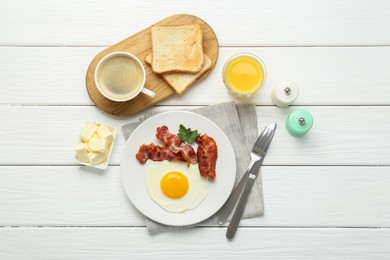 Delicious breakfast with sunny side up egg served on white wooden table, flat lay