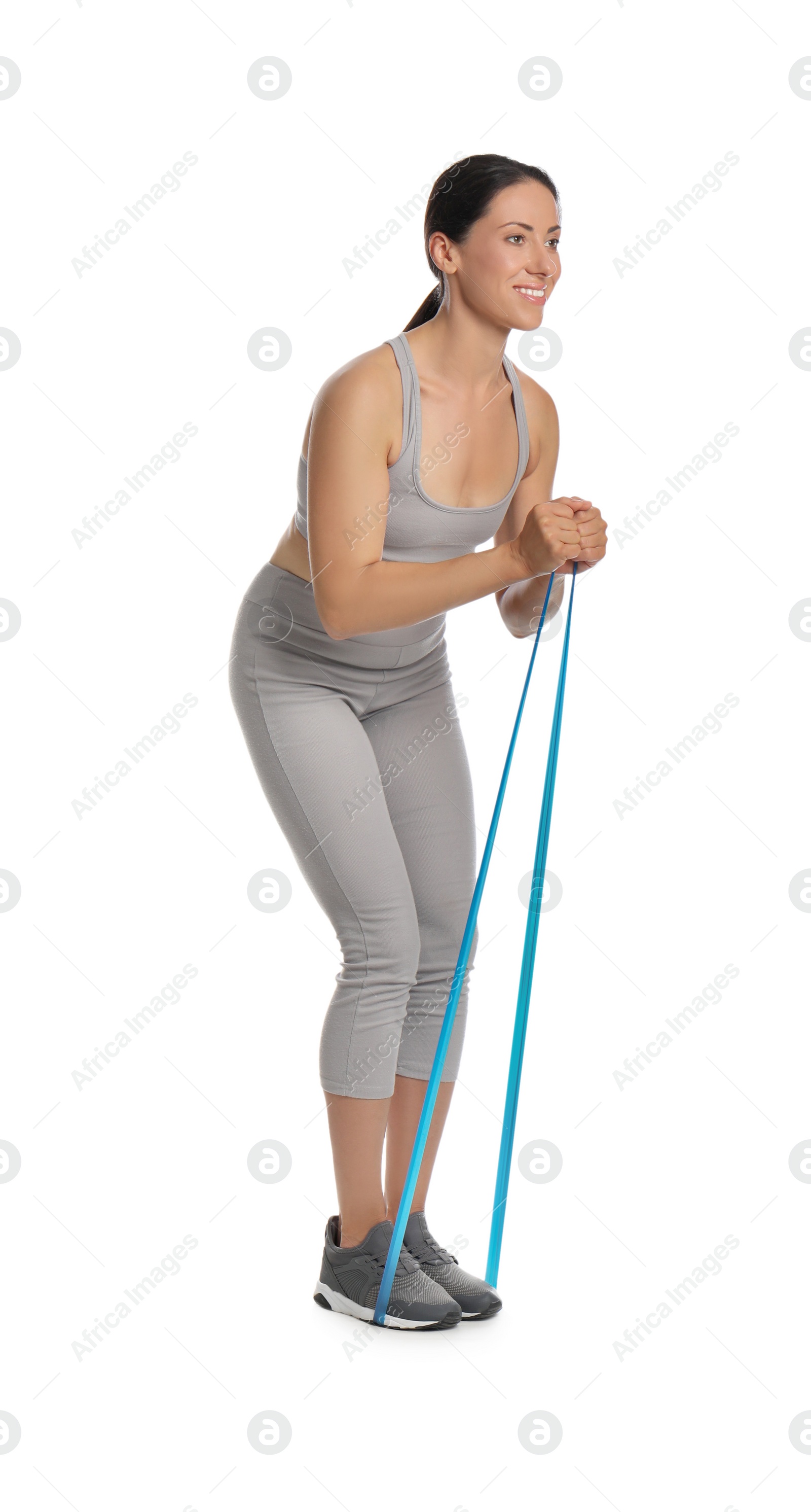 Photo of Woman doing sportive exercise with fitness elastic band on white background