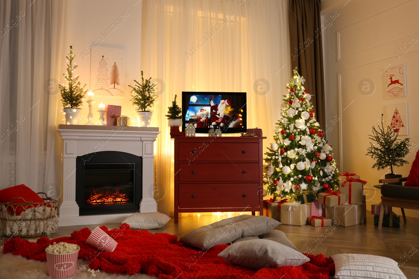 Image of Stylish living room interior with TV set, Christmas tree and fireplace