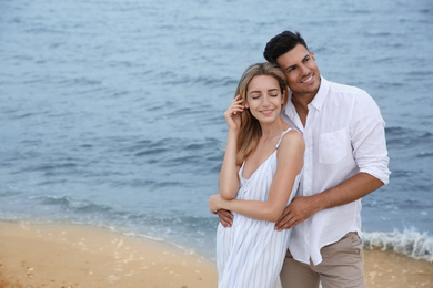 Happy couple on beach, space for text. Romantic walk