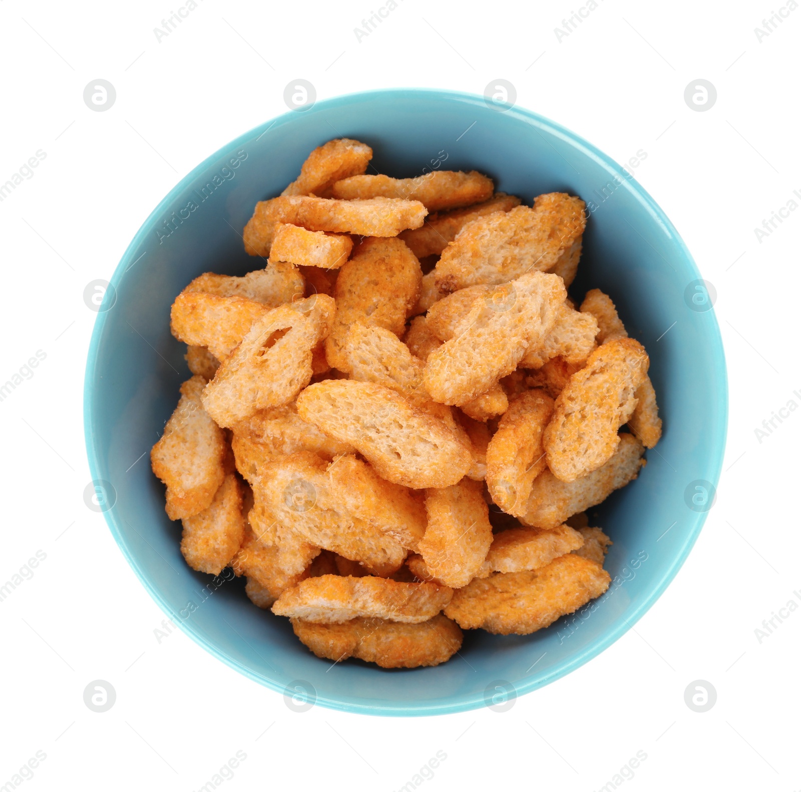 Photo of Delicious crispy rusks in bowl on white background, top view