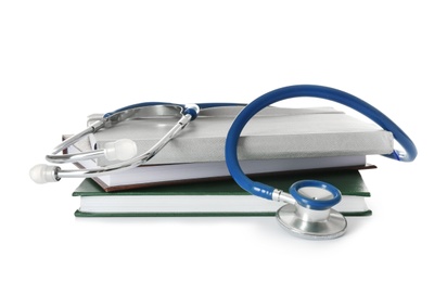 Photo of Stethoscope and notebooks on white background. Medical students stuff