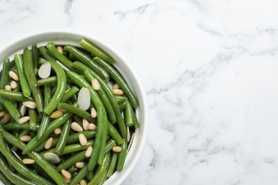 Bowl of tasty salad with green beans on white marble table, top view. Space for text