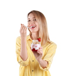 Young attractive woman eating tasty yogurt on white background